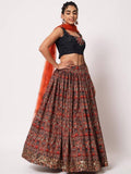 Woman in floral lehenga with black crop top and orange dupatta, elegant ethnic wear for women