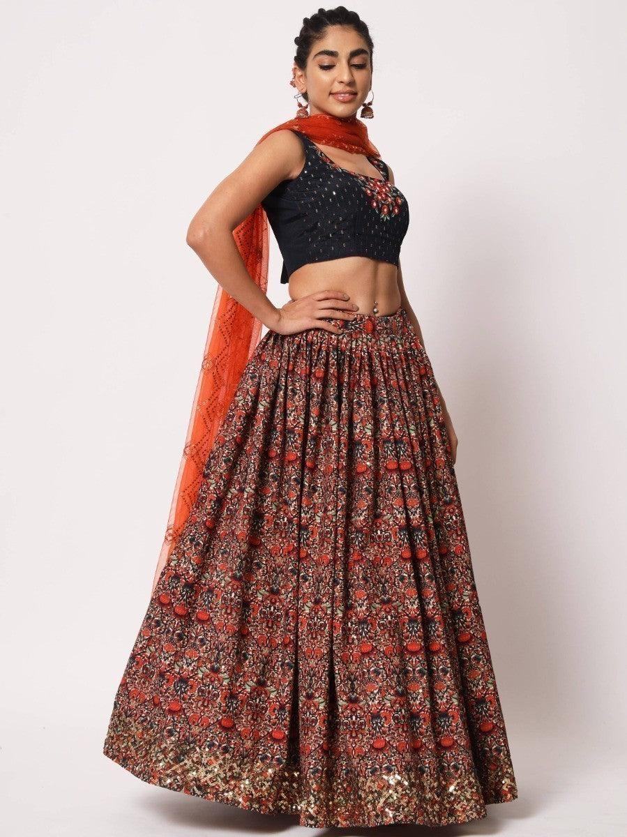 Woman in floral lehenga with black crop top and orange dupatta, elegant ethnic wear for women