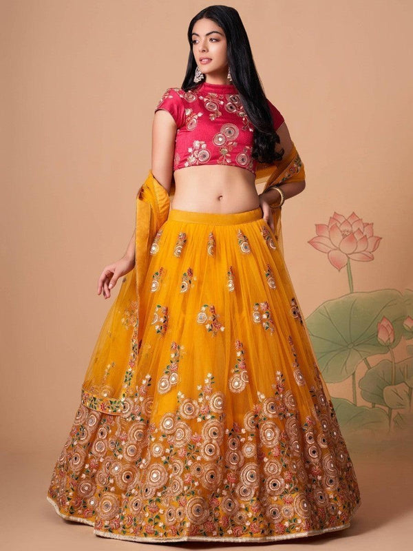 Impressive Yellow Mirror Work Net Reception Wear Lehenga Choli