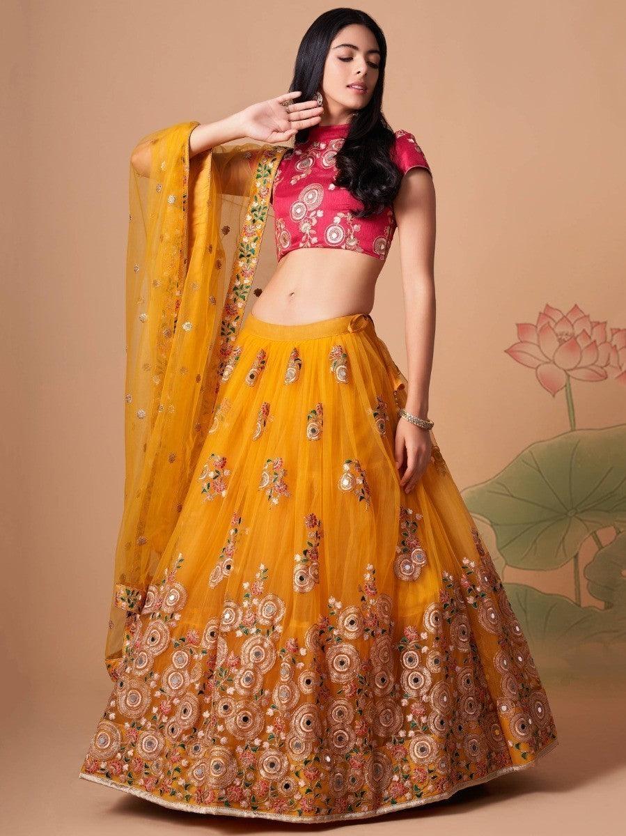 Impressive Yellow Mirror Work Net Reception Wear Lehenga Choli
