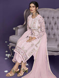Elegant pink embroidered women's outfit with gold detailing, styled with heels and statement earrings