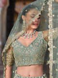 Wonderful Pista Green Embroidered Net Engagement Wear Lehenga Choli