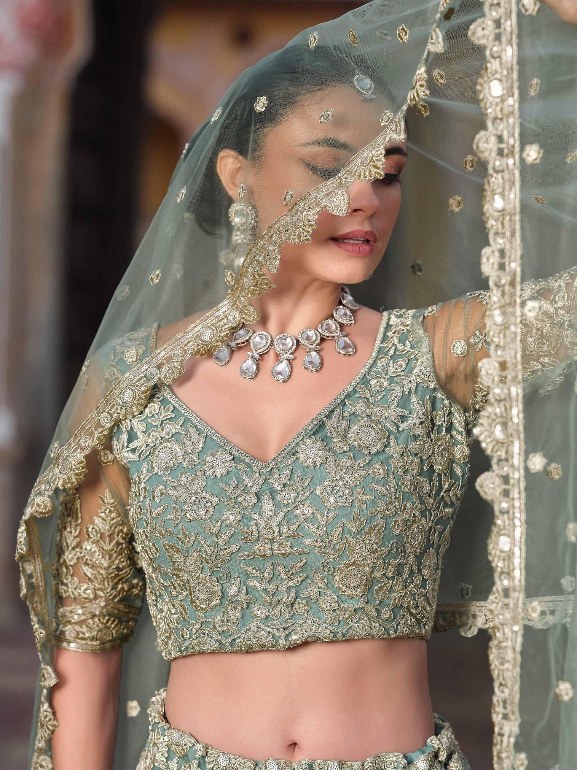Wonderful Pista Green Embroidered Net Engagement Wear Lehenga Choli