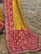 Fascinating Yellow Bandhani Printed Satin Reception Wear Saree With Blouse